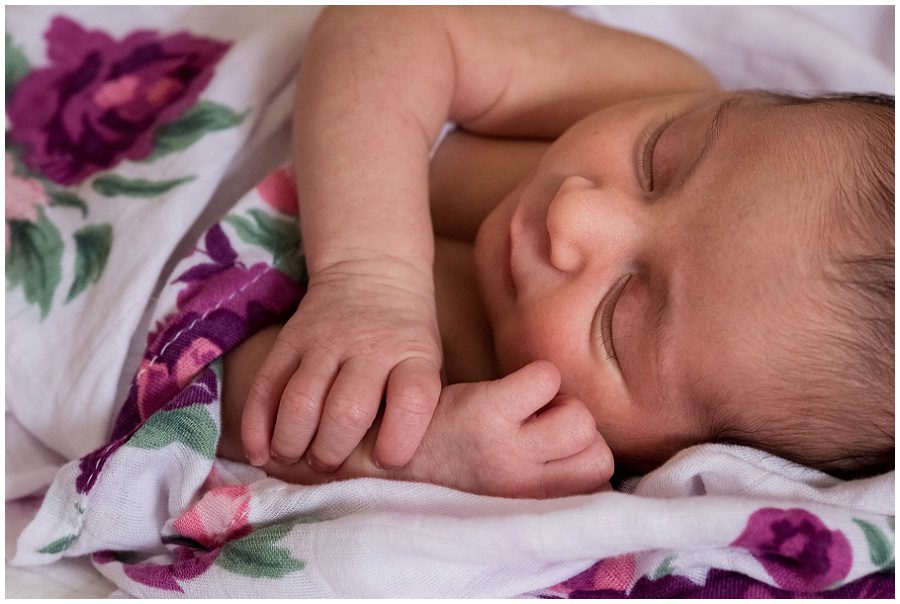 Newborn snuggling in a swaddle