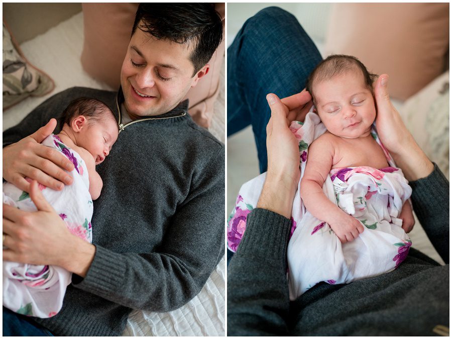 Father lying on day bed with newborn on chest as he looks down at baby that is swaddled in a white wrap