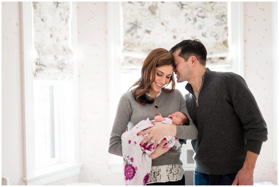 Snuggles for mom by dad as she embraces their newborn