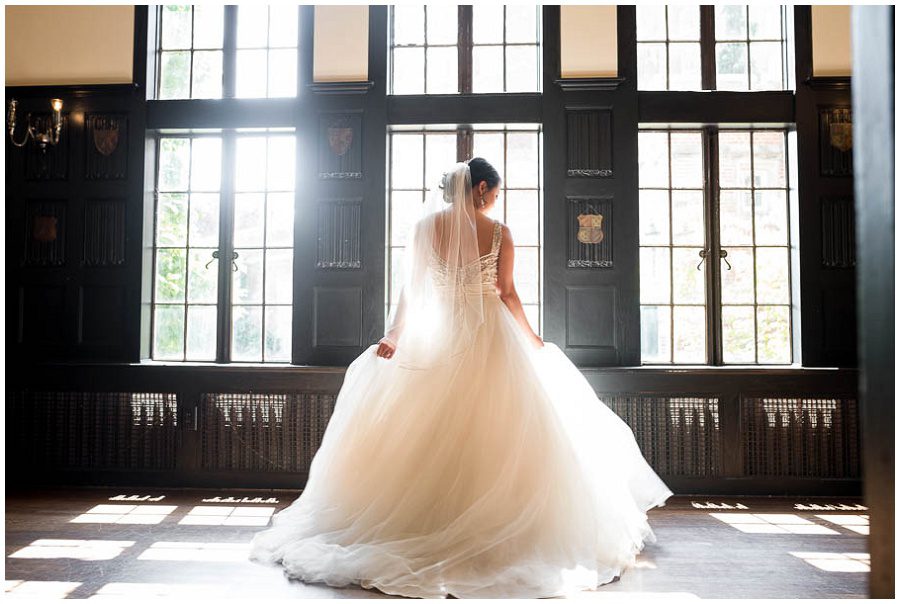 Bride getting ready by window  at Alden Castle in Boston Longwood Wedding Venue 