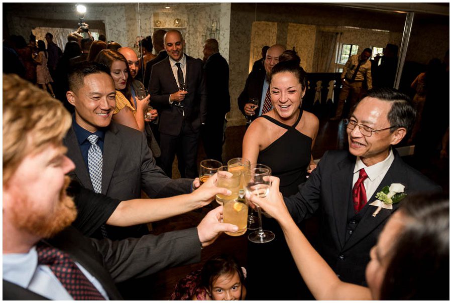 Cheers at cocktail hour at Alden Castle in Boston Longwood Wedding Venue 