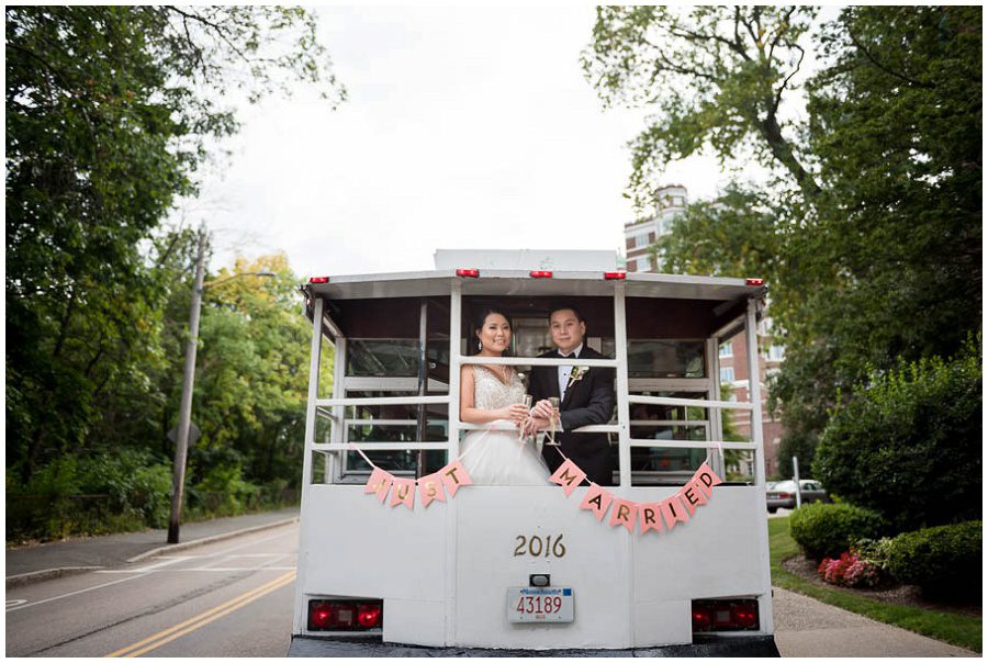 bride and groom with trolley outside bride and groom portraits Alden Castle in Boston Longwood Wedding Venue