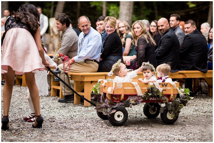 Kids in a wagon with flower girl and ring bearer during Ceremony space at Granite Ridge Estate & Barn Wedding Sweet Pea Floral Designs www.sweetpeafloraldesignsme.com Hair and makeup by sarah depault www.sarahdepaultbeauty.com and Noel Sarazin Dress by Ve' Lace Bridal and Allure