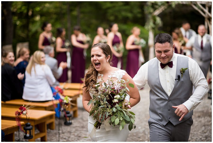 Granite Ridge Estate & Barn Wedding bride and groom recessional during ceremony Sweet Pea Floral Designs www.sweetpeafloraldesignsme.com Hair and makeup by sarah depault www.sarahdepaultbeauty.com and Noel Sarazin Dress by Ve' Lace Bridal and Allure