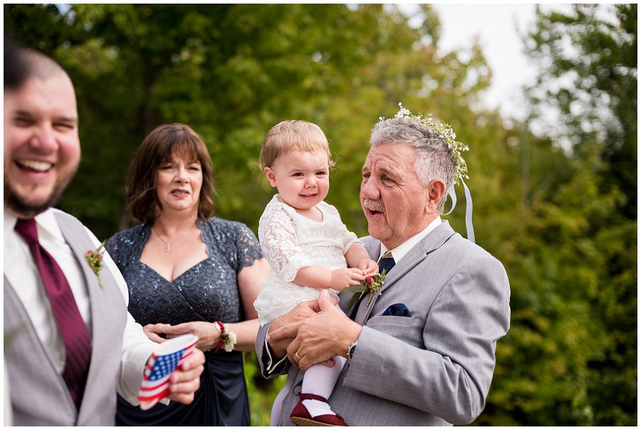 Grandfather with grandchild during wedding portraits