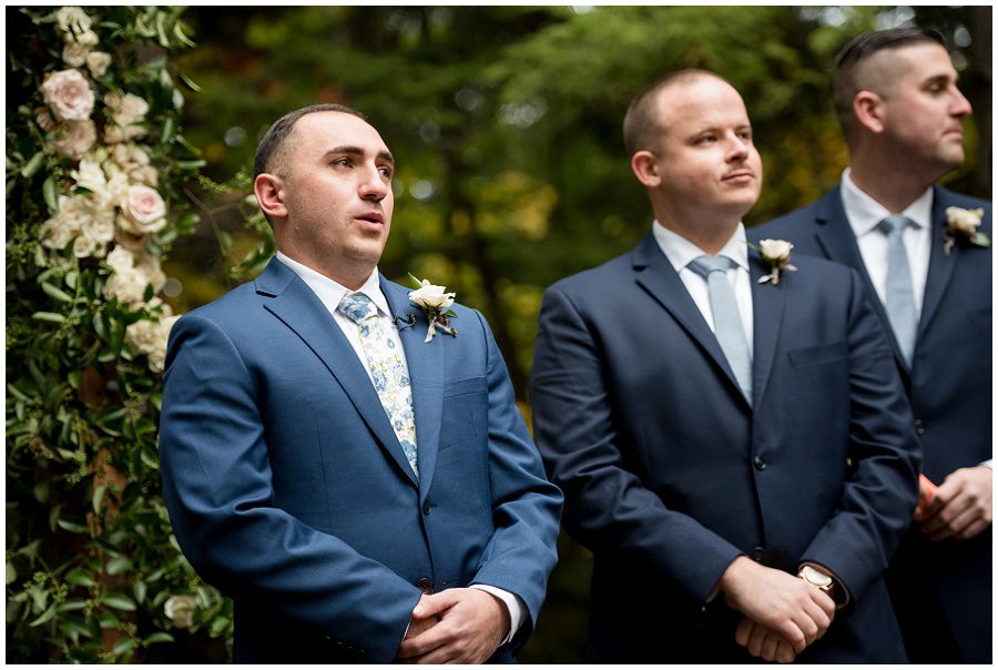 Groom sees his bride coming towards him down the aisle