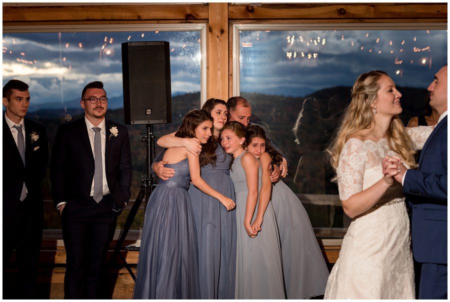 bridesmaids crying during emotional first dance.