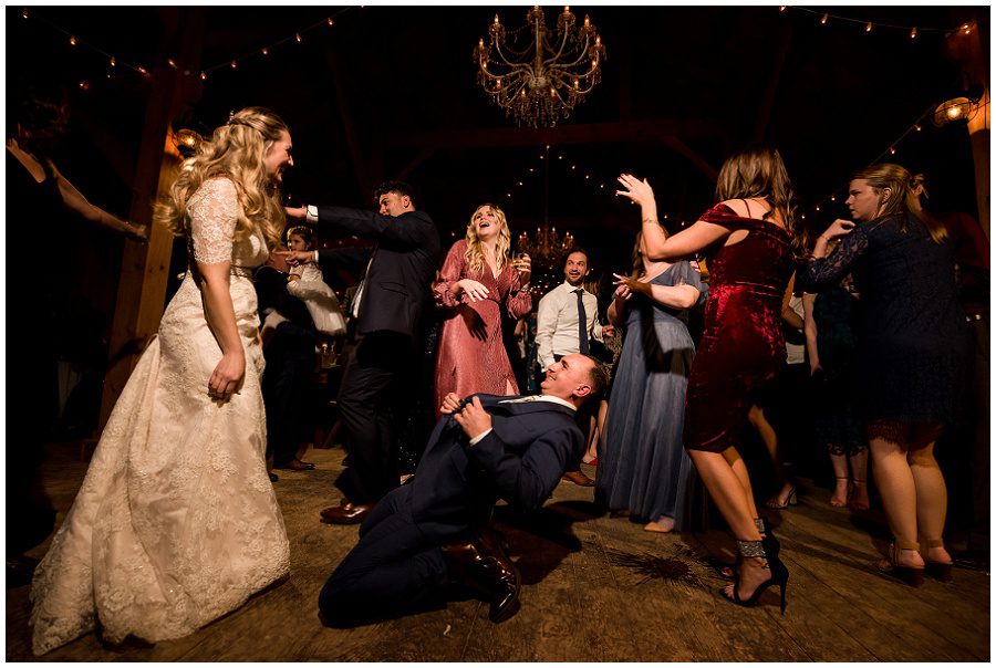 Groom dancing at reception partying on the dance floor