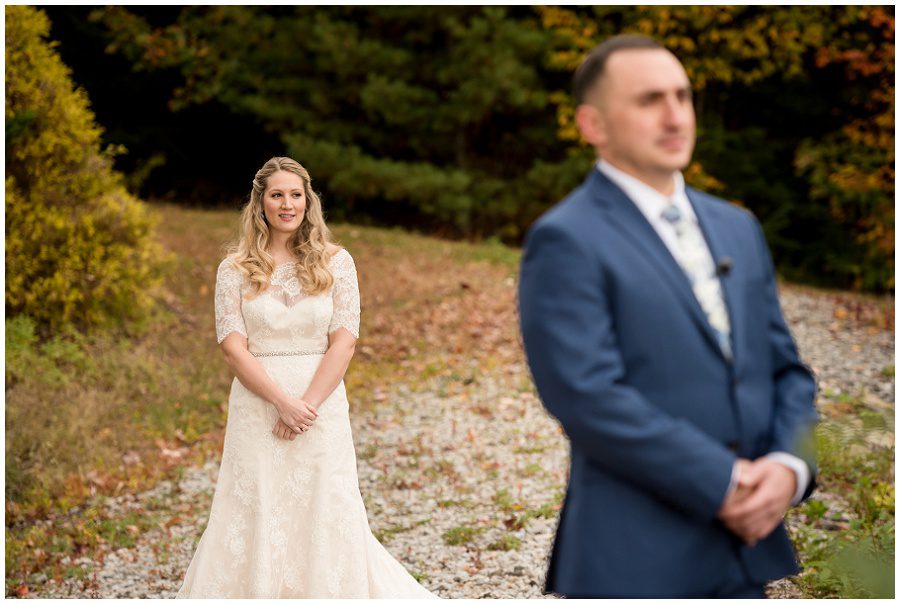 First look moment focus on the bride at Granite Ridge Estate and Barn in Norway Maine