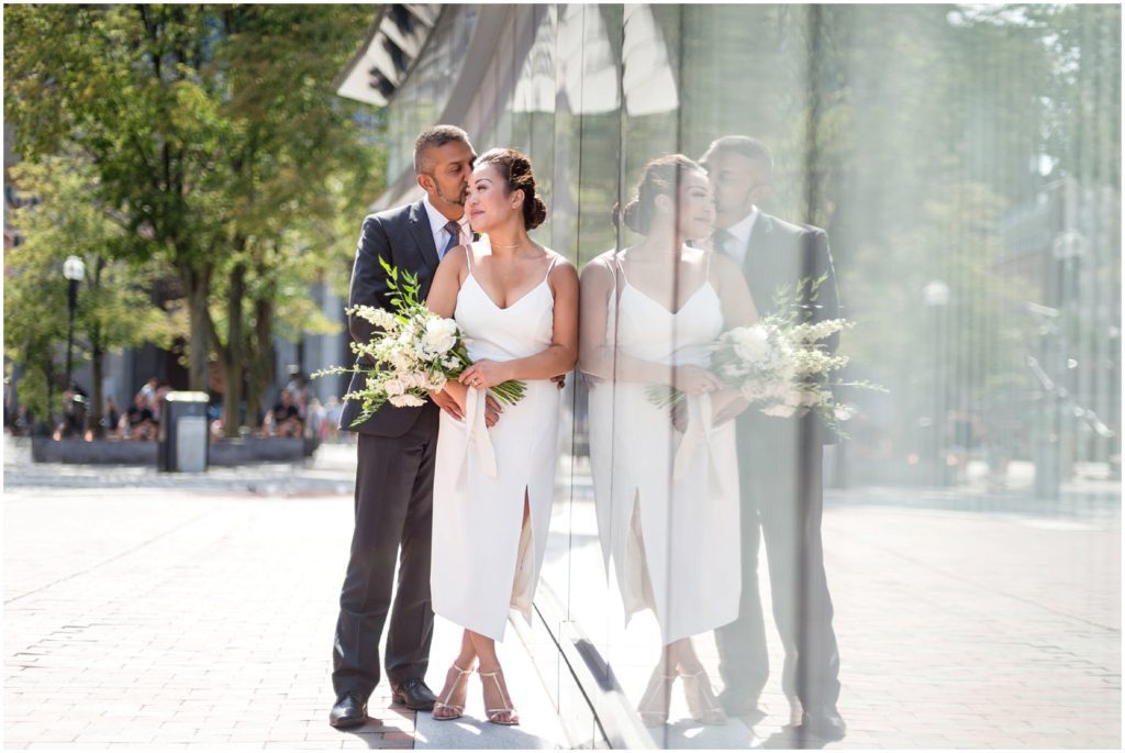 Bride and Groom after wedding civil ceremony posing outside Boston City Hall Faneuil Hall