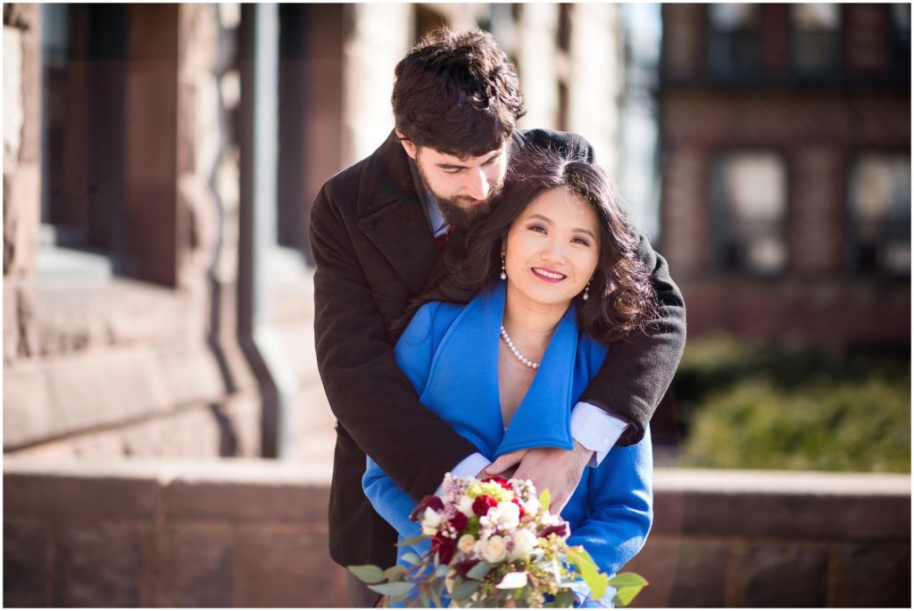 Newly married couple celebrating outside Cambridge city hall.