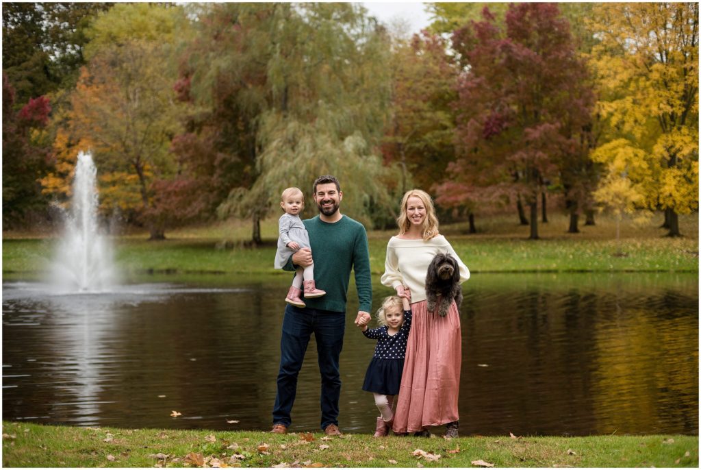 Family posed by pond Boston family photographer Fall foliage Larz Anderson