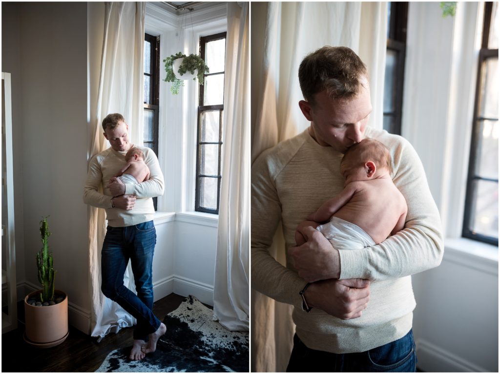Newborn being held by father