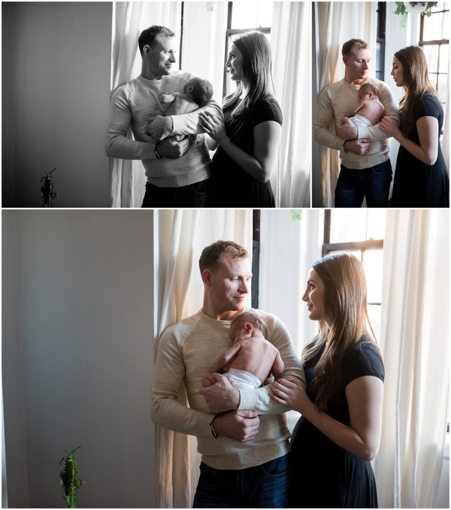 Newborn being held by father and mother