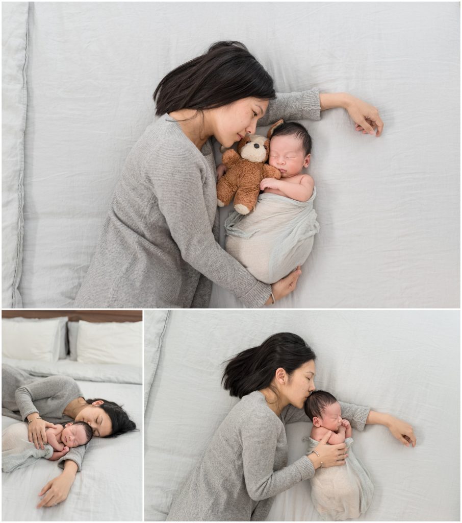 Mom snuggling newborn son on bed