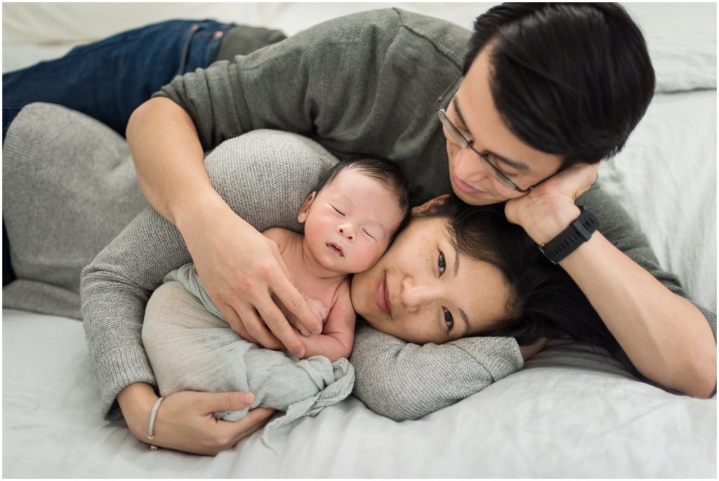 Parents holding newborn and cuddling