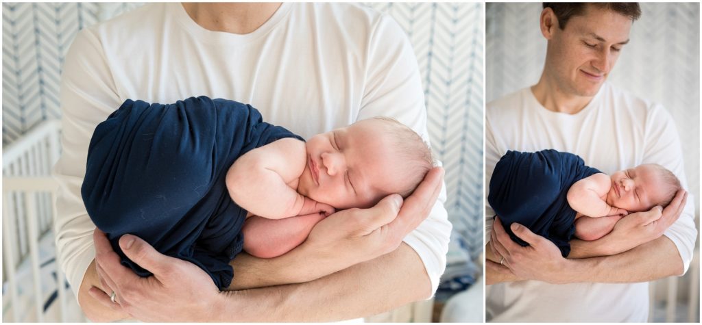 new dad holding newborn son in nursery