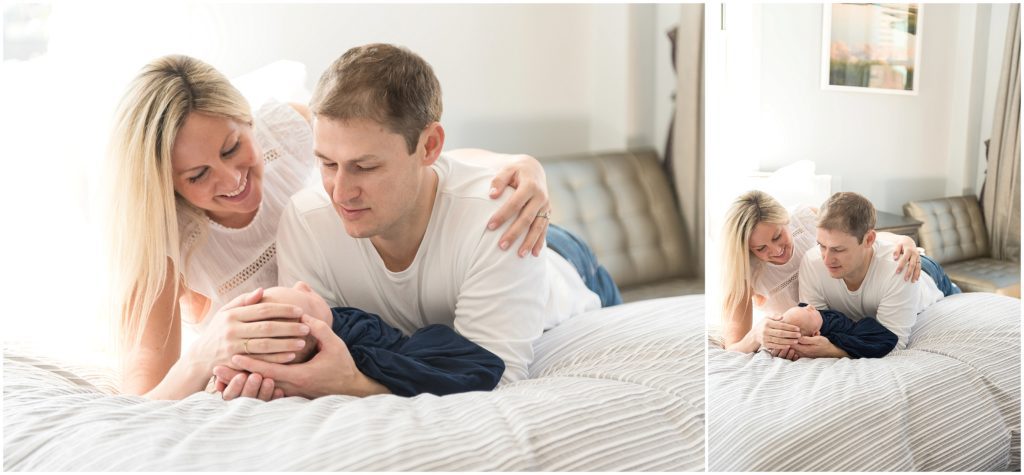Parents holding newborn on bed in bedroom newborn lifestyle session