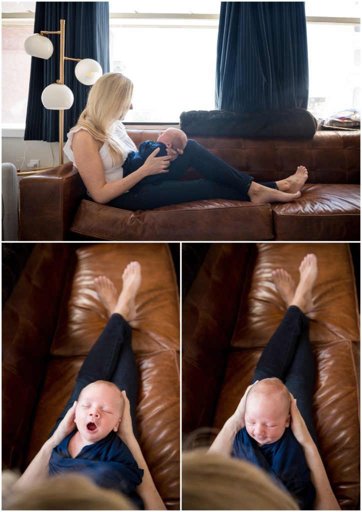Mom cradling newborn on couch in loft apartment in Boston