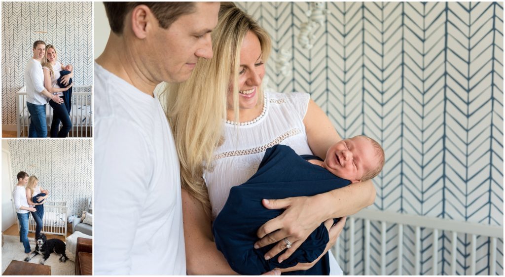 Smiling newborn baby in parent's arms in nursery