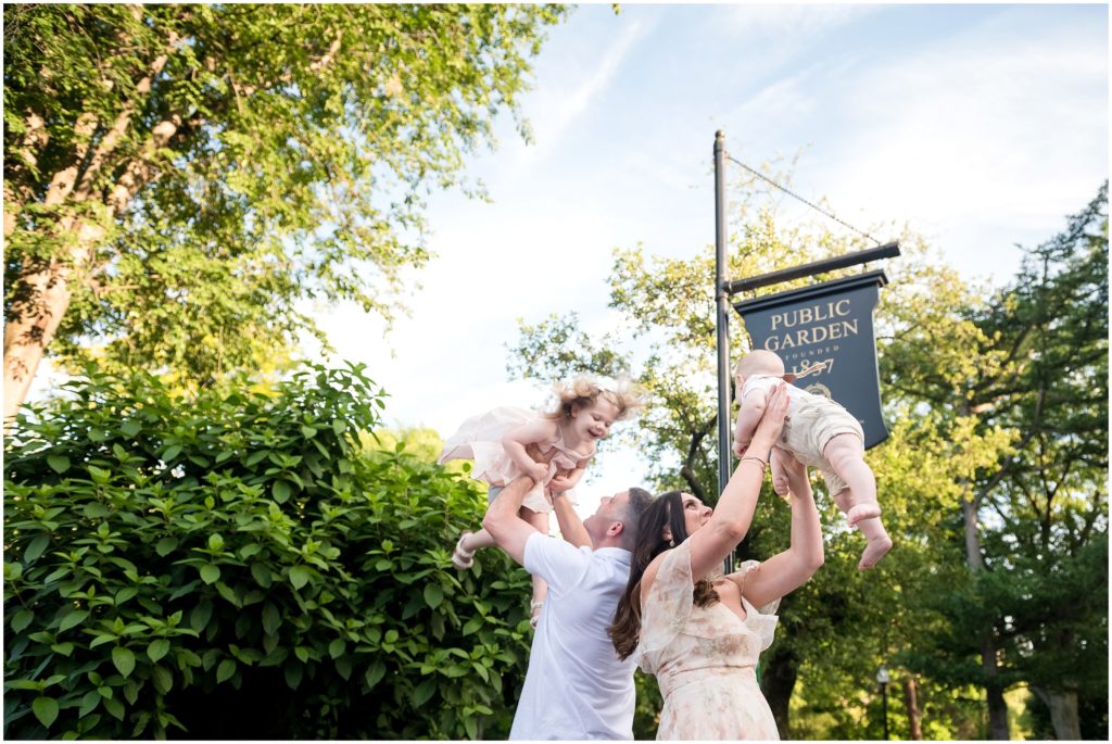 Family lifting children at Boston Public Garden