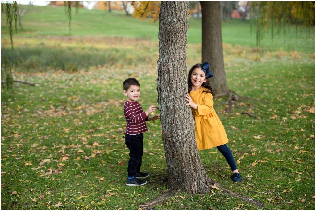 Siblings at park near tree at Larz Anderson