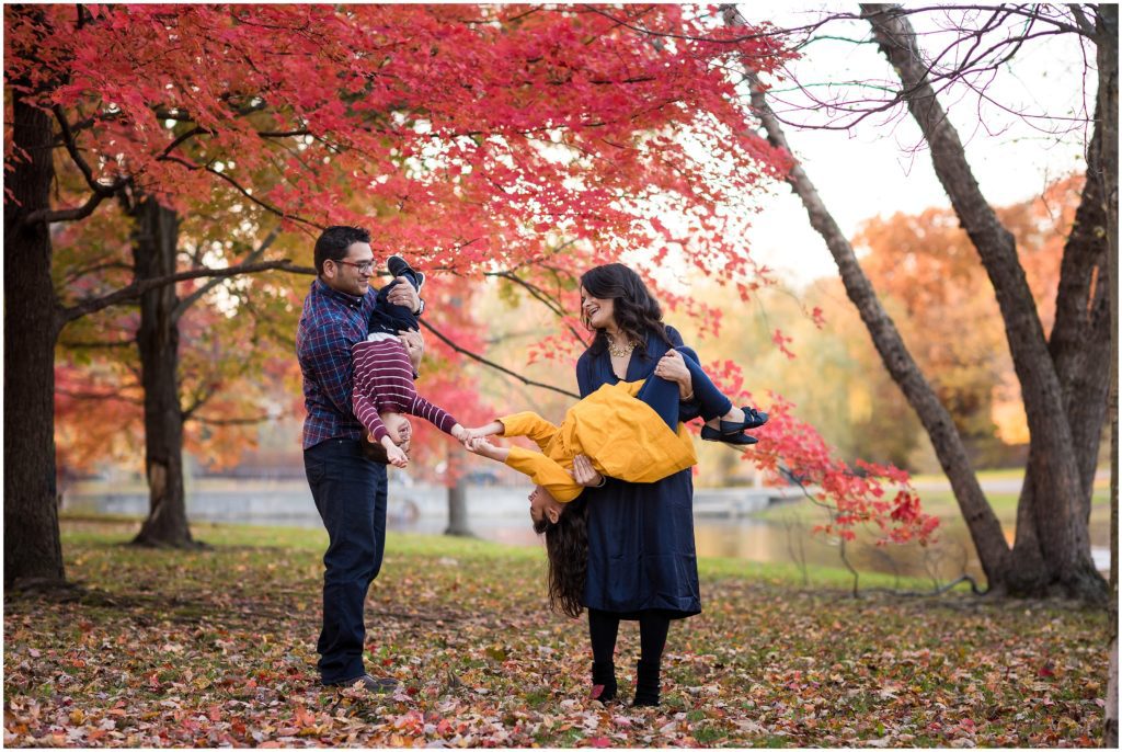 Siblings reaching for each other in family photo