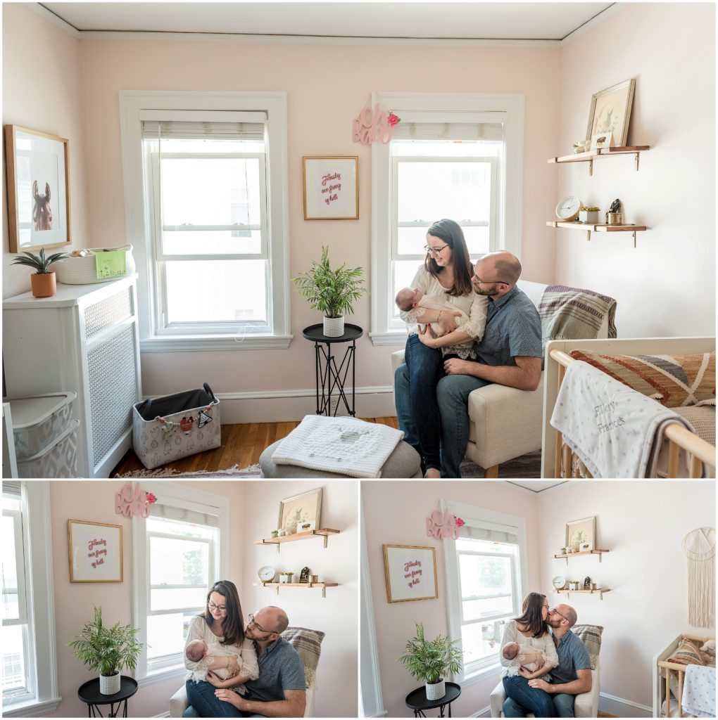 Parents holding baby in nursery