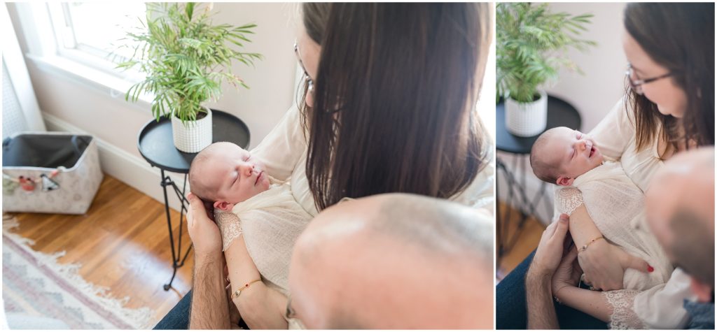 Newborn smiles in parents' arms