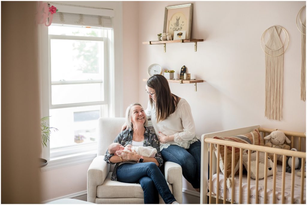 Grandmother holding grandchild and daughter