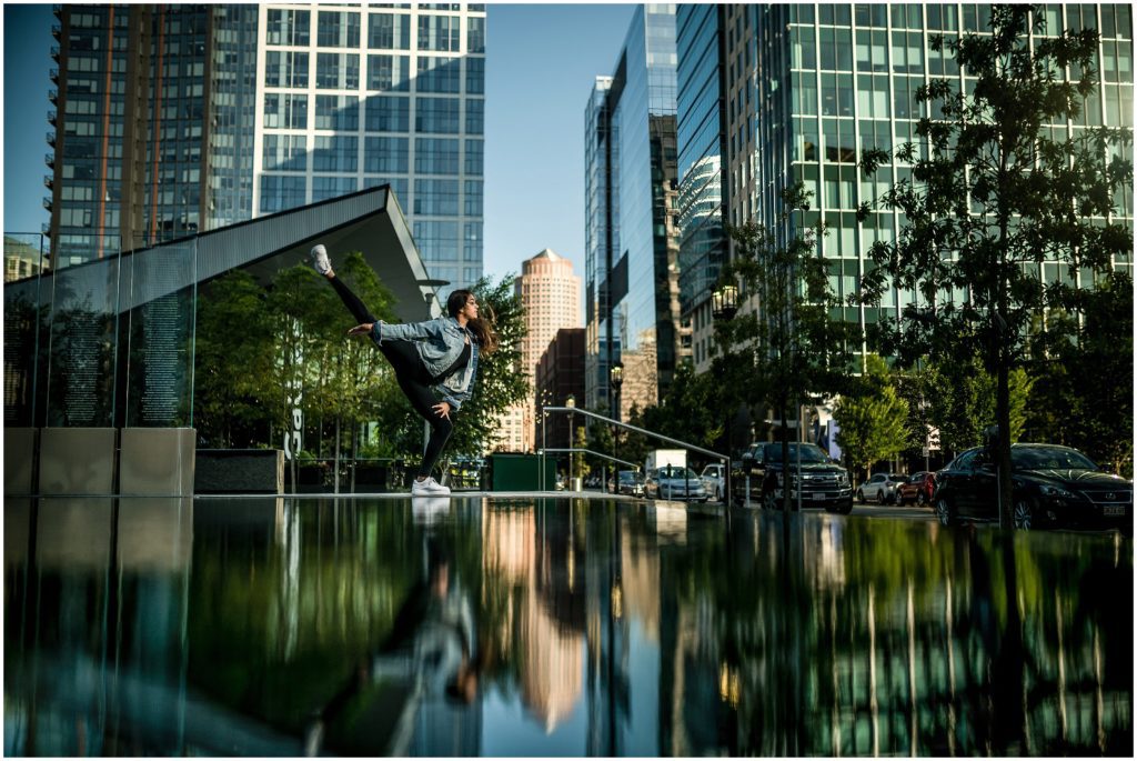 Dancer in front of skyscrapers in Boston Seaport District Boston senior session