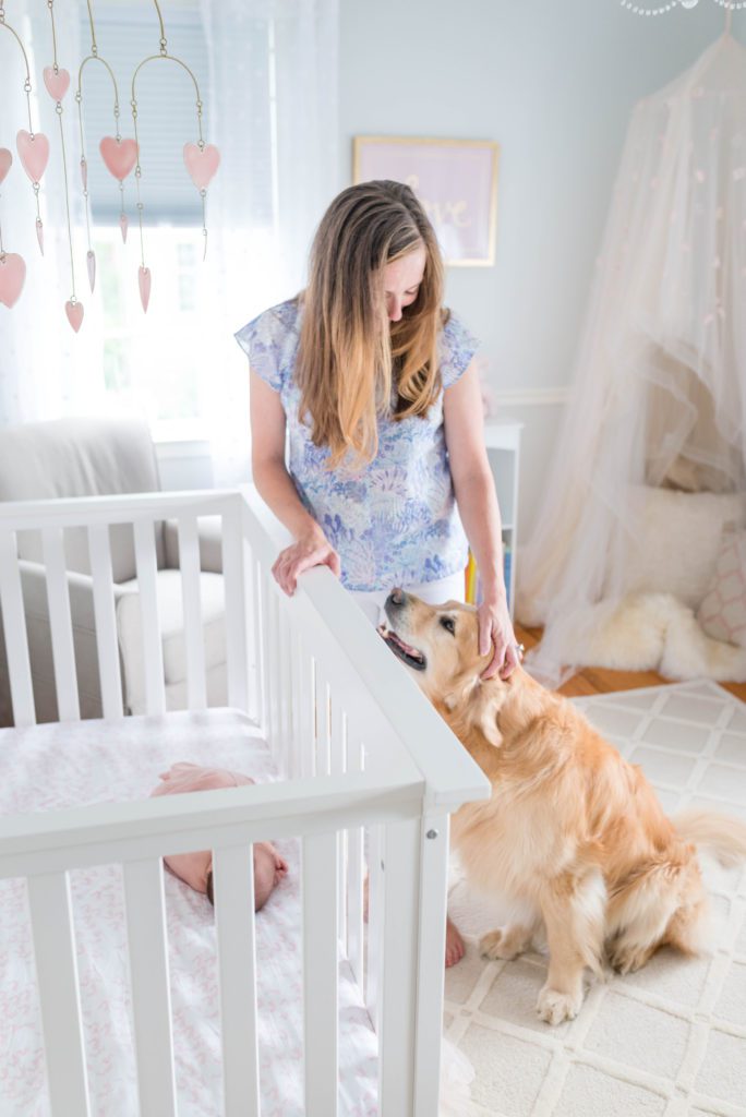 Newborn in crib with mom and pup | newborn photos at home