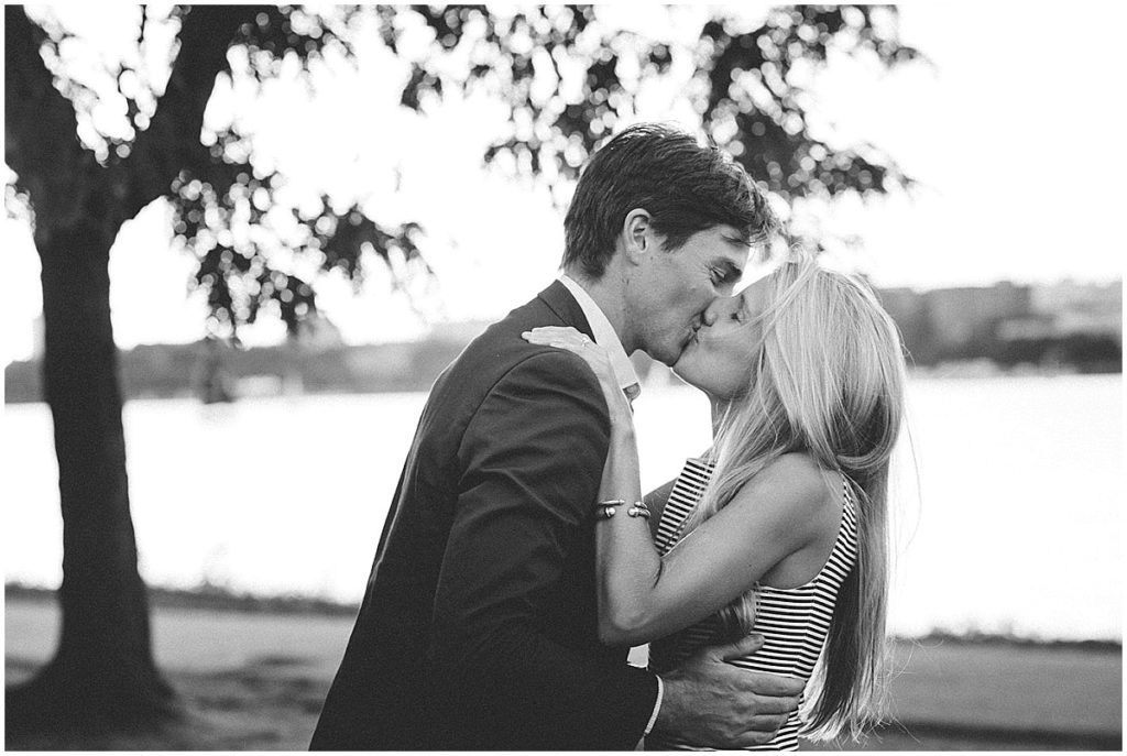 Newly engaged couple kissing during an engagement photo session.