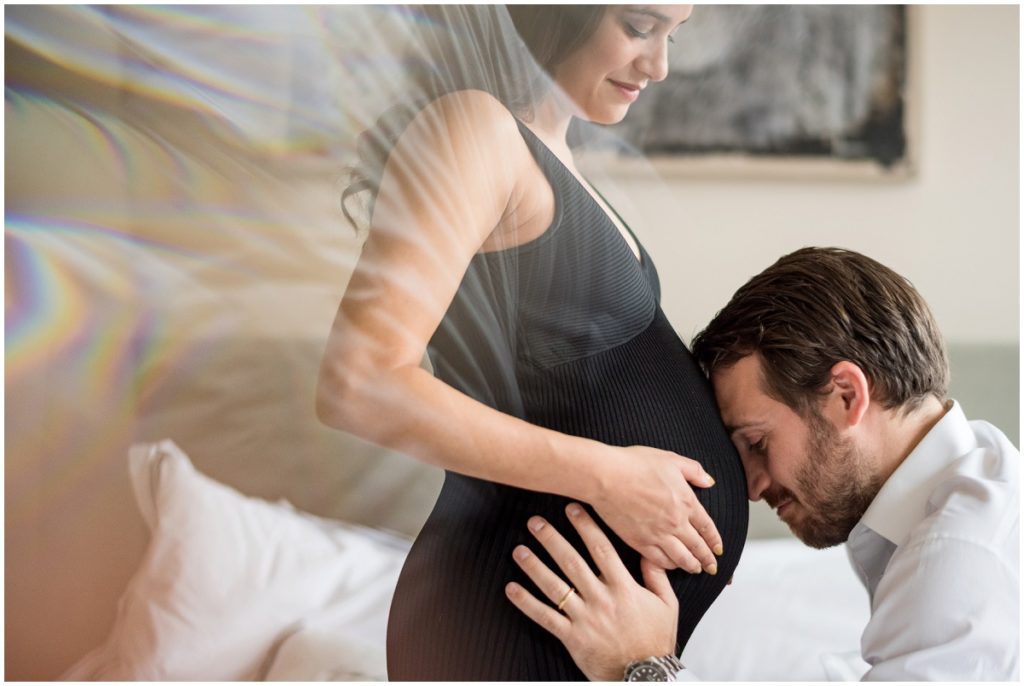 maternity photo featuring belly bump with husband kissing stomach
