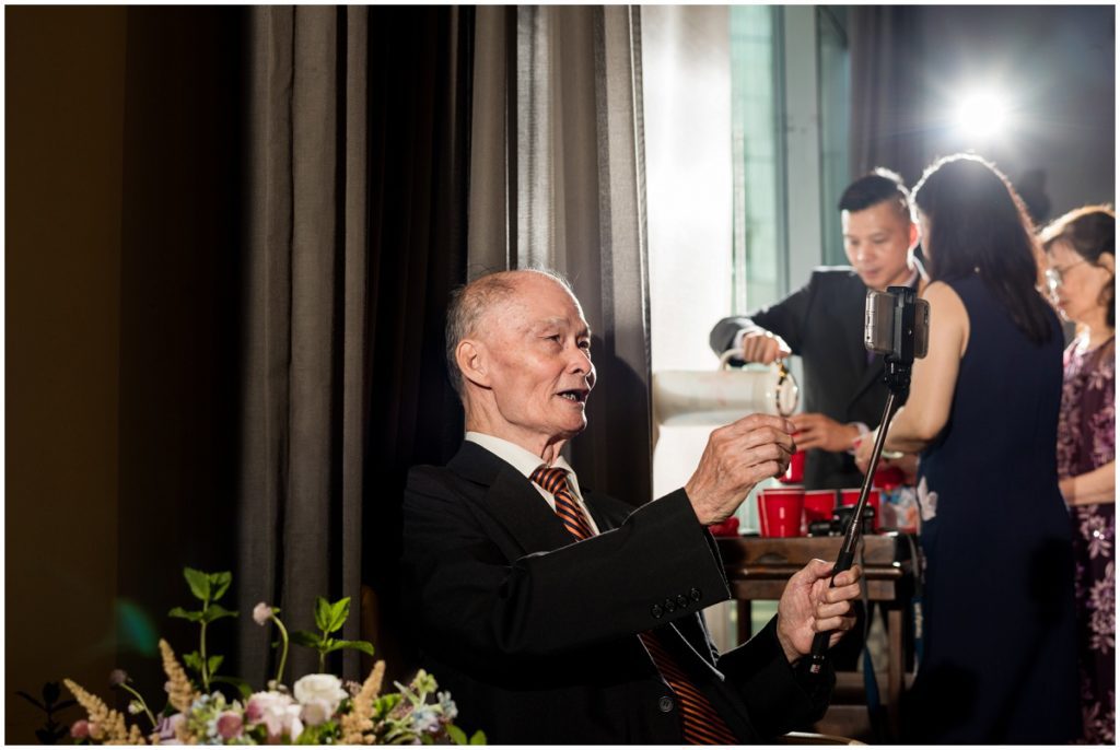 uncle taking selfie during tea ceremony