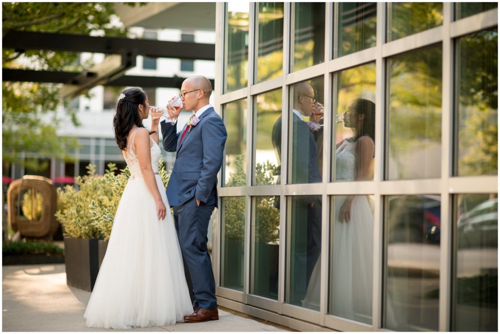 Champagne toasts for couple outside venue Catalyst restaurant