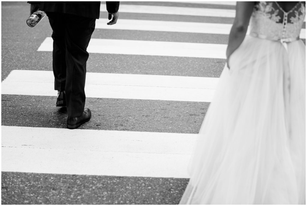 Bride and groom crossing crosswalk in Cambridge MA