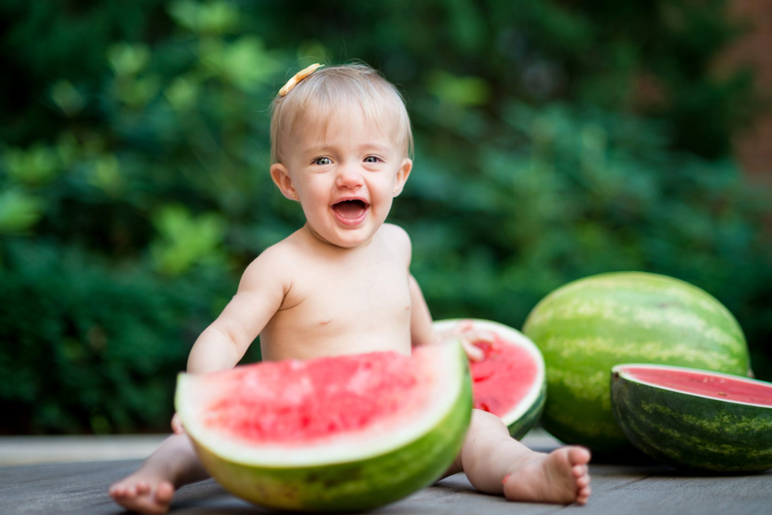 Baby eating watermelon during family session 2020