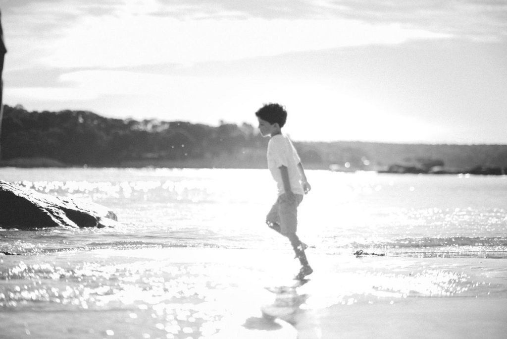 Wingaersheek Beach family photo boy running through water black and white