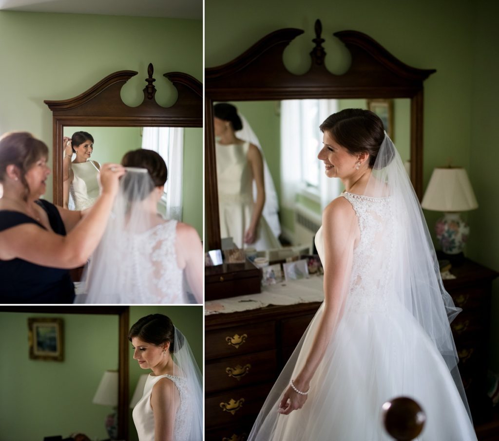 mom adjusting veil on the bride