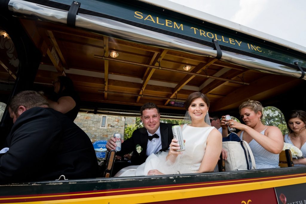 Couple on the trolley after wedding ceremony heading to reception