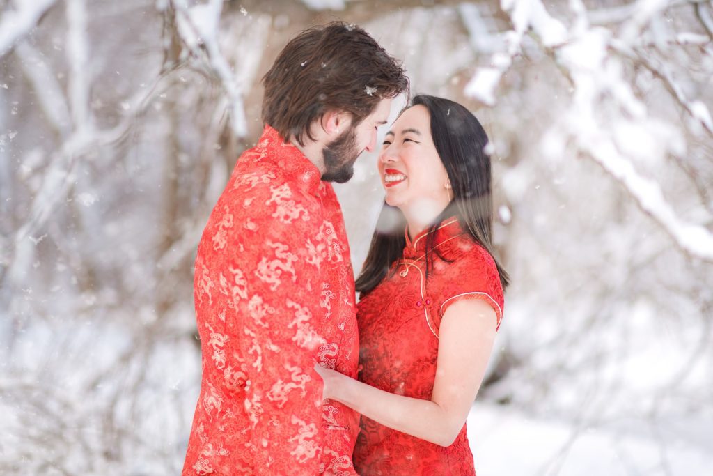 snow falling on couple during their photography session