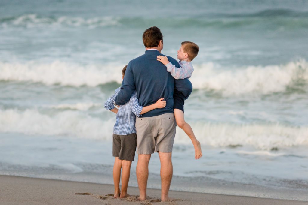 dad hugging his sons on the beach in Cape Cod, MA