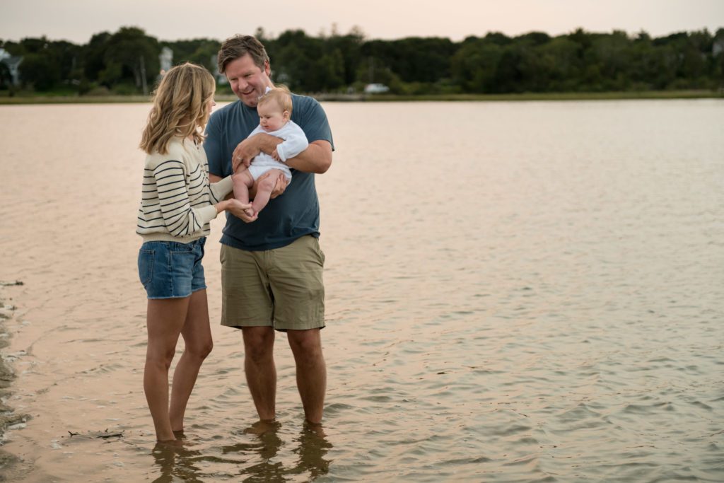 family in the ocean by the beach in Cape Cod