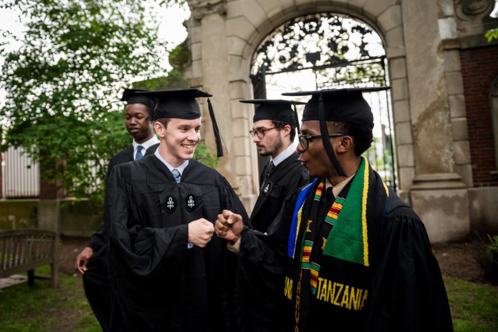 Harvard Grad with his friends in a picture on convocation day