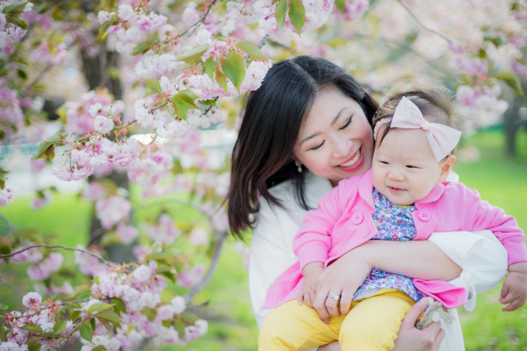 Spring outdoor photo session with baby wearing pink and flowers on her outfit