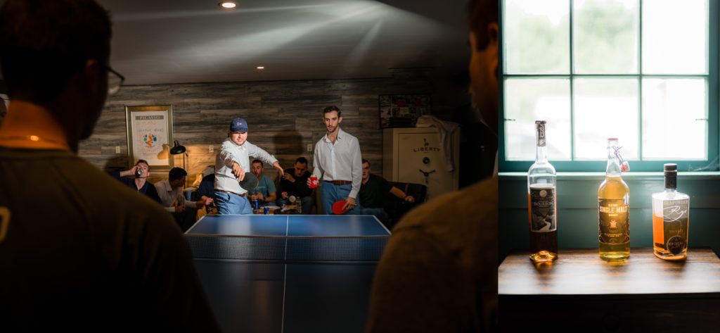 Groom playing ping pong with the guys