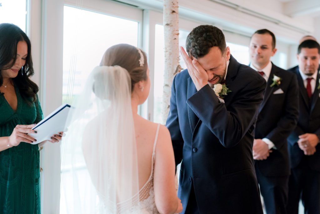 Groom crying during wedding ceremony